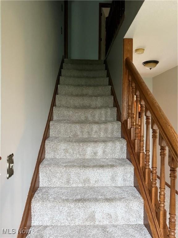 staircase featuring baseboards