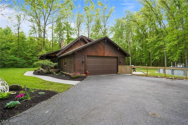 1354 N Pricetown Rd, Diamond, OH 44412 - view of home's exterior featuring asphalt driveway, a chimney, and an attached garage