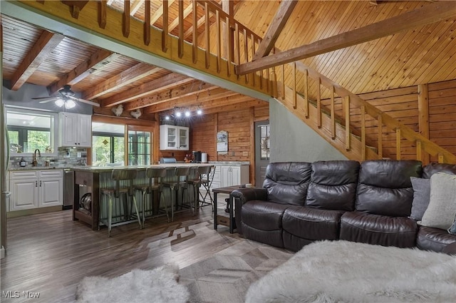 1354 N Pricetown Rd, Diamond, OH 44412 - living area featuring wooden walls, beamed ceiling, wood finished floors, a ceiling fan, and wooden ceiling