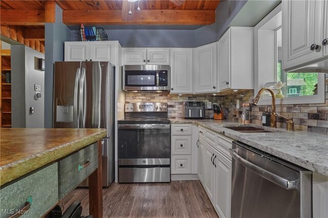 1354 N Pricetown Rd, Diamond, OH 44412 - kitchen featuring appliances with stainless steel finishes, a sink, beamed ceiling, dark wood-type flooring, and tasteful backsplash