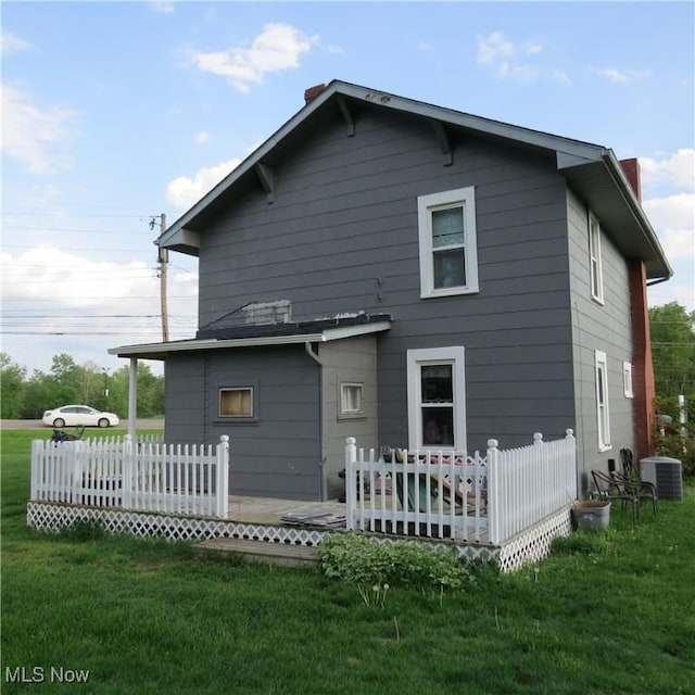 1093 Alliance Rd NW, Minerva, OH 44657 - rear view of property featuring a chimney and central AC