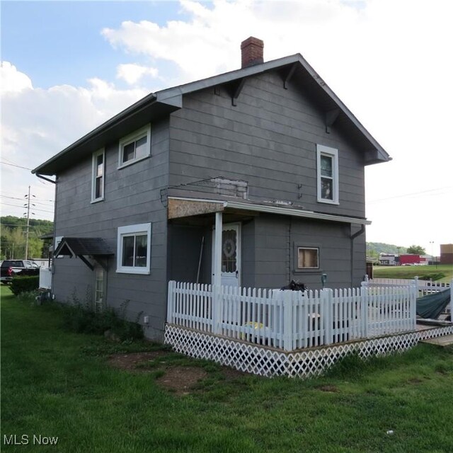 1093 Alliance Rd NW, Minerva, OH 44657 - back of property featuring a chimney and a lawn