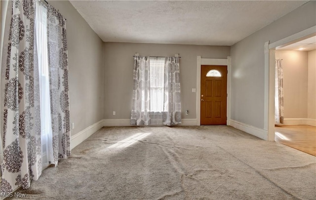 601 Short St, Dover, OH 44622 - carpeted entryway featuring baseboards and a textured ceiling