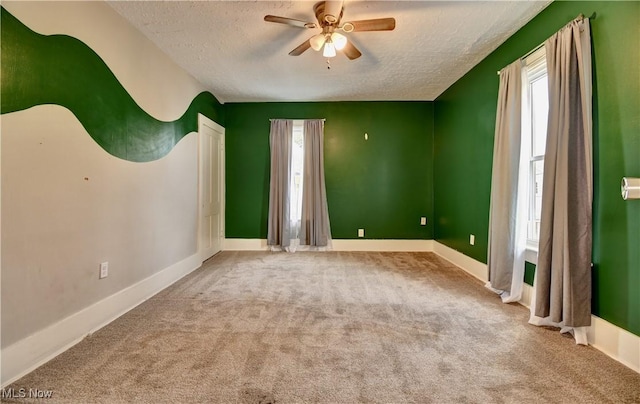 601 Short St, Dover, OH 44622 - spare room with a textured ceiling, a ceiling fan, carpet flooring, and baseboards