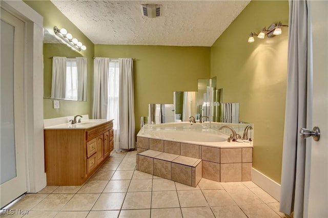 601 Short St, Dover, OH 44622 - bathroom with a textured ceiling, tile patterned flooring, a garden tub, and vanity