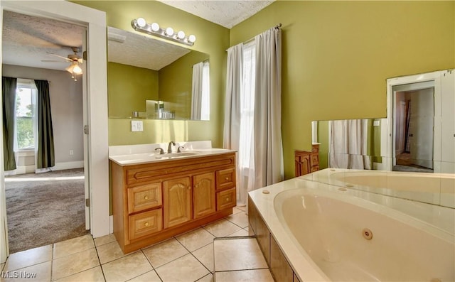 601 Short St, Dover, OH 44622 - full bathroom featuring ceiling fan, a textured ceiling, a whirlpool tub, vanity, and tile patterned floors