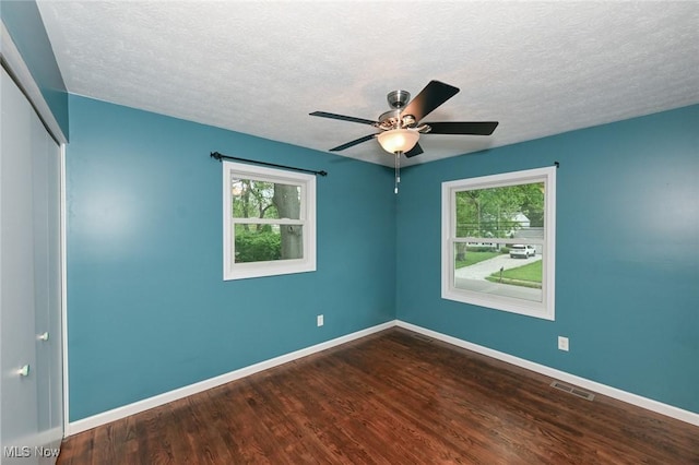 3428 Hiwood Ave, Stow, OH 44224 - unfurnished room featuring healthy amount of natural light, baseboards, dark wood-style flooring, and a textured ceiling