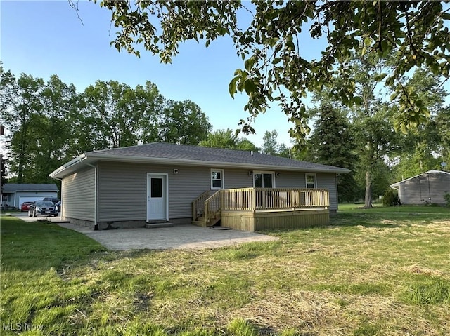 4378 Victoria Ter SE, Warren, OH 44484 - back of property featuring a patio, a lawn, and a deck