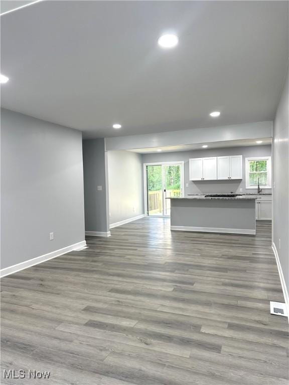 4378 Victoria Ter SE, Warren, OH 44484 - unfurnished living room with recessed lighting, baseboards, and wood finished floors