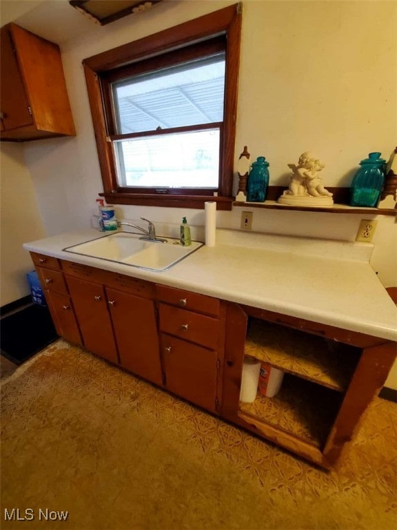 7417 Broadview Rd, Seven Hills, OH 44131 - kitchen with a sink, light countertops, light floors, and brown cabinets