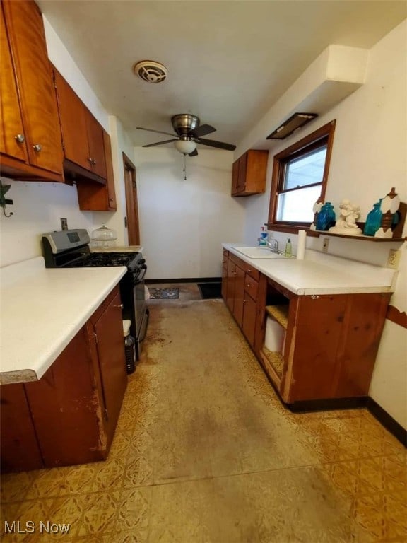 7417 Broadview Rd, Seven Hills, OH 44131 - kitchen with gas stove, a sink, light countertops, and baseboards