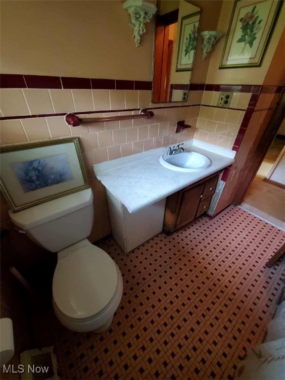 7417 Broadview Rd, Seven Hills, OH 44131 - bathroom with tile walls, toilet, wainscoting, and vanity