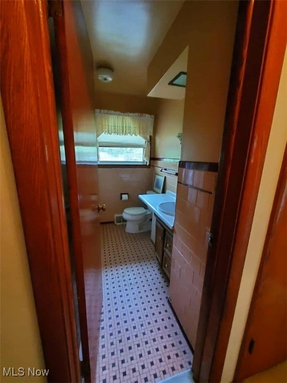 7417 Broadview Rd, Seven Hills, OH 44131 - half bathroom with toilet, vanity, and tile patterned floors