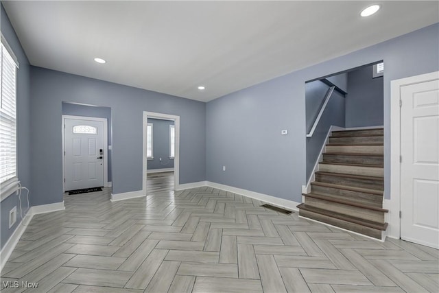 entrance foyer featuring stairs, baseboards, and recessed lighting