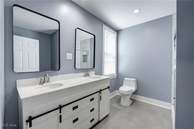 bathroom with baseboards, toilet, double vanity, a shower with door, and tile patterned flooring