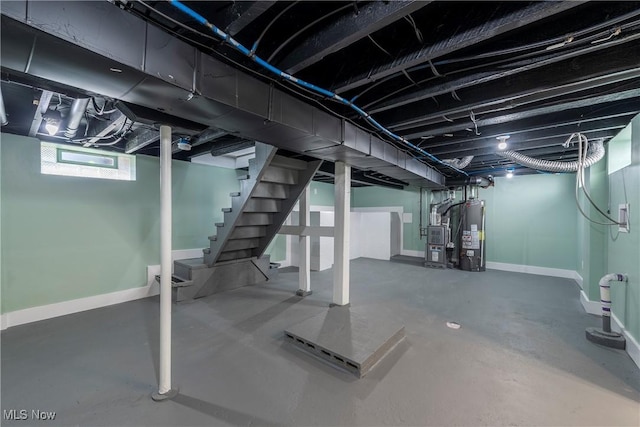 basement with water heater, baseboards, and stairway
