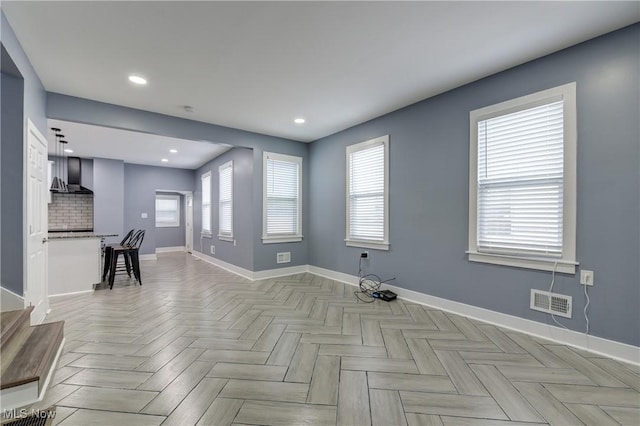 empty room featuring baseboards and recessed lighting