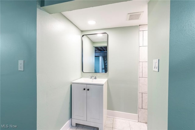 bathroom with baseboards, vanity, and tile patterned flooring