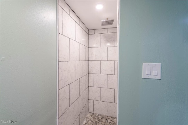 full bath with a tile shower
