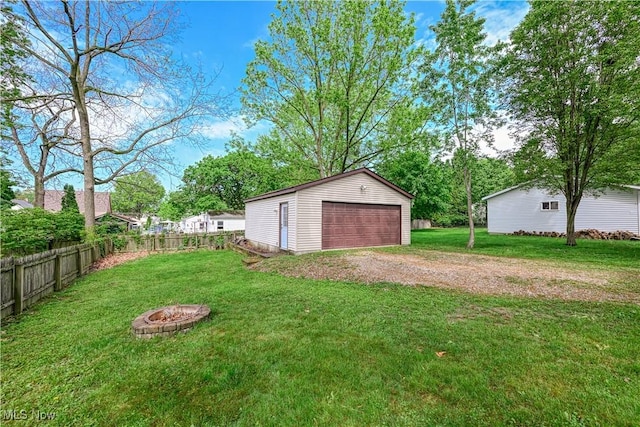 2534 6th St, Cuyahoga Falls, OH 44221 - view of yard featuring an outdoor structure, a garage, and a fire pit