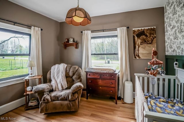 6319 Columbus Rd NE, Louisville, OH 44641 - bedroom featuring multiple windows, light wood-type flooring, and baseboards