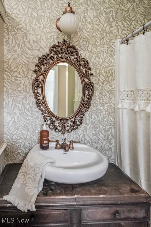 6319 Columbus Rd NE, Louisville, OH 44641 - bathroom featuring wallpapered walls and vanity