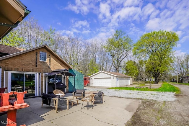 6319 Columbus Rd NE, Louisville, OH 44641 - view of patio with a detached garage, an outdoor structure, and an outdoor living space