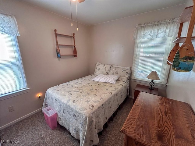 bedroom featuring multiple windows, carpet floors, and baseboards