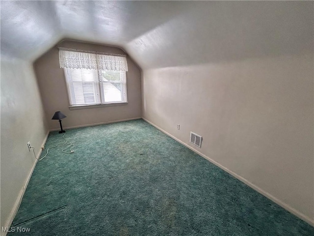 additional living space with lofted ceiling, carpet floors, and baseboards