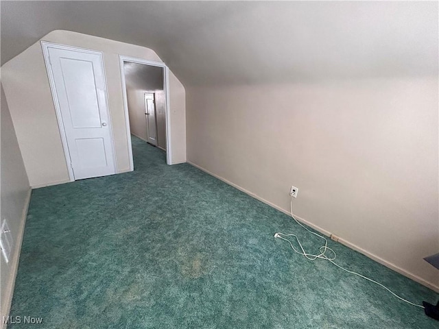 bonus room with lofted ceiling, carpet flooring, and baseboards