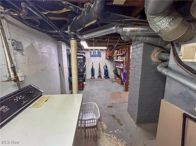 unfinished below grade area featuring washer / dryer