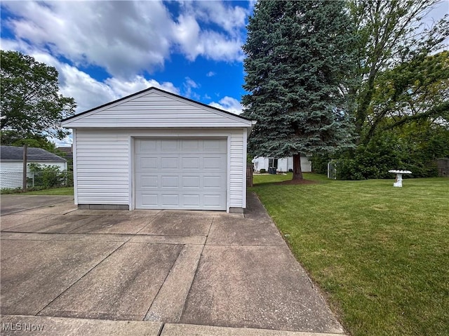detached garage featuring driveway