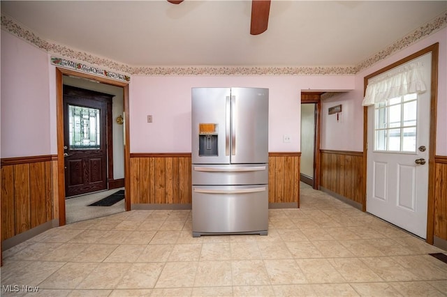 390 E Clark St, East Palestine, OH 44413 - kitchen with stainless steel refrigerator with ice dispenser, wainscoting, plenty of natural light, wood walls, and ceiling fan