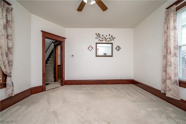 390 E Clark St, East Palestine, OH 44413 - carpeted empty room with a ceiling fan, stairs, and baseboards