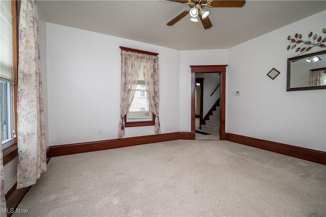 390 E Clark St, East Palestine, OH 44413 - empty room featuring carpet floors, healthy amount of natural light, and ceiling fan