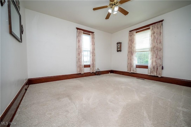 390 E Clark St, East Palestine, OH 44413 - carpeted spare room featuring baseboards and a ceiling fan