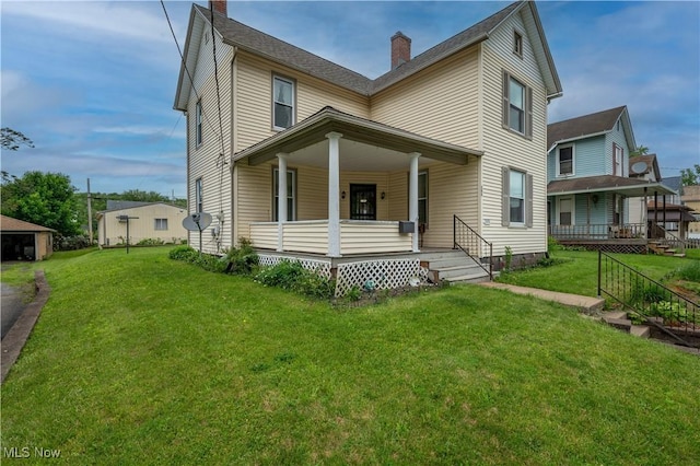 390 E Clark St, East Palestine, OH 44413 - view of front of house with a porch, a chimney, and a front yard