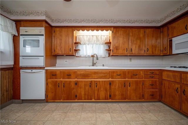 390 E Clark St, East Palestine, OH 44413 - kitchen featuring a sink, white appliances, a warming drawer, and brown cabinets