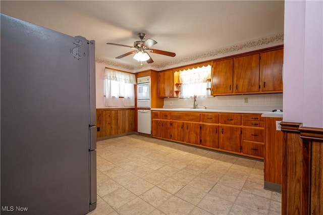390 E Clark St, East Palestine, OH 44413 - kitchen with white appliances, brown cabinets, ceiling fan, light countertops, and light floors