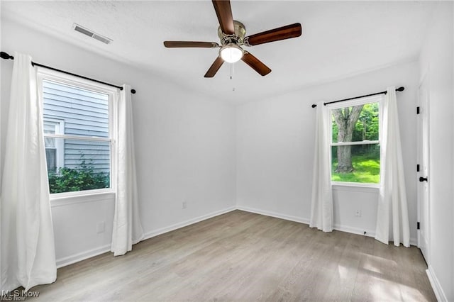 1212 Eastwood Ave, Mayfield Heights, OH 44124 - spare room featuring light wood-style floors, ceiling fan, and baseboards