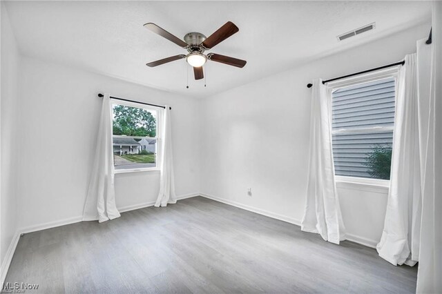 1212 Eastwood Ave, Mayfield Heights, OH 44124 - unfurnished room with wood finished floors, ceiling fan, and baseboards