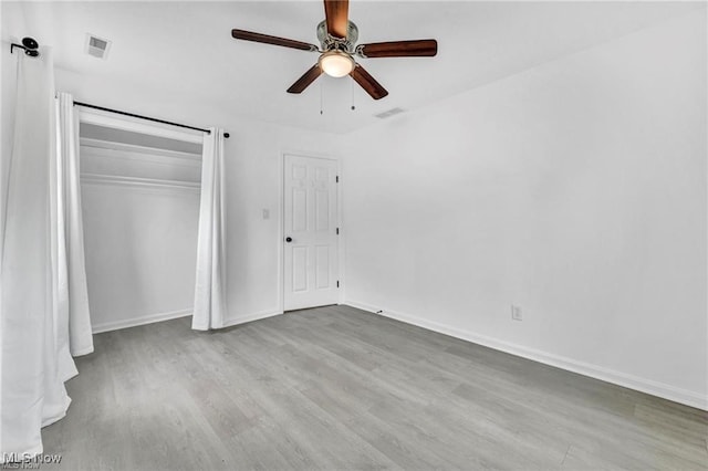 1212 Eastwood Ave, Mayfield Heights, OH 44124 - unfurnished bedroom featuring wood finished floors, a closet, baseboards, and a ceiling fan