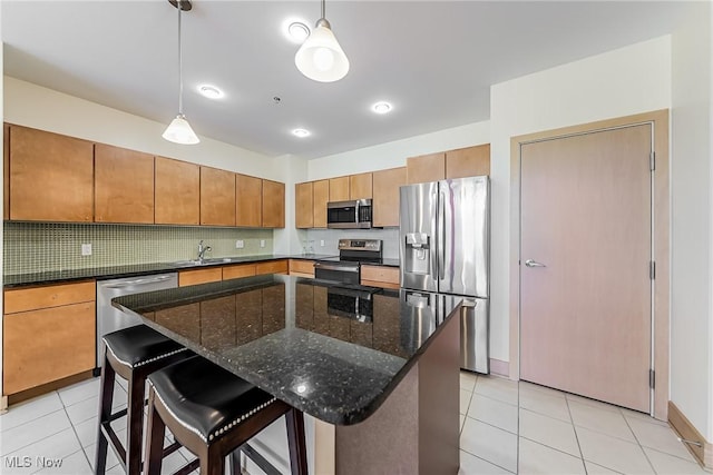2030 Euclid Ave Unit 201, Cleveland, OH 44115 - kitchen featuring appliances with stainless steel finishes, decorative backsplash, light tile patterned floors, a sink, and decorative light fixtures