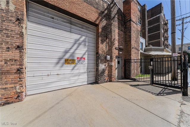 2030 Euclid Ave Unit 201, Cleveland, OH 44115 - property entrance with brick siding, a gate, a garage, and fence