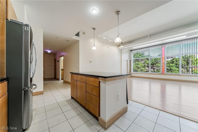 2030 Euclid Ave Unit 201, Cleveland, OH 44115 - kitchen with freestanding refrigerator, dark countertops, light tile patterned floors, and open floor plan