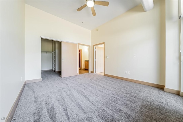 2030 Euclid Ave Unit 201, Cleveland, OH 44115 - unfurnished bedroom featuring carpet flooring, baseboards, a ceiling fan, ensuite bath, and vaulted ceiling