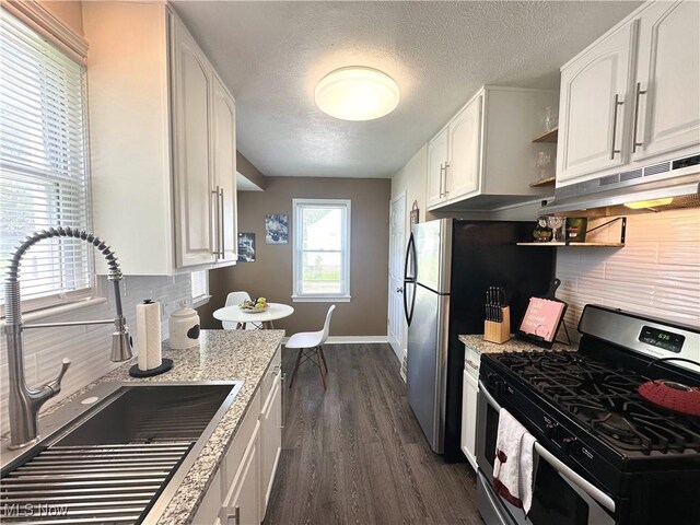 19708 Sunset Dr, Warrensville Heights, OH 44122 - kitchen with appliances with stainless steel finishes, a sink, under cabinet range hood, open shelves, and white cabinets