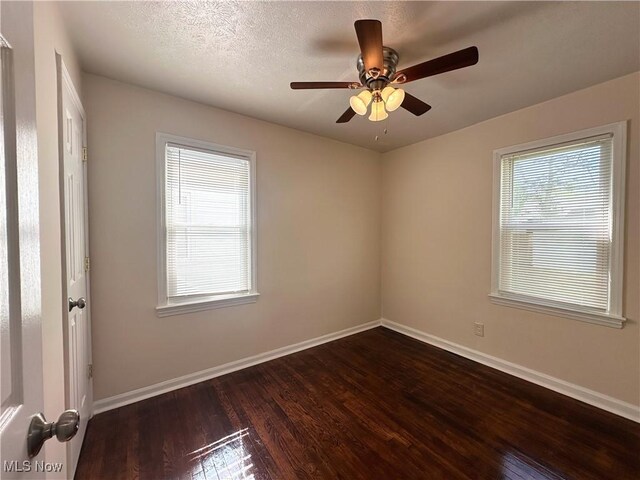 19708 Sunset Dr, Warrensville Heights, OH 44122 - unfurnished room featuring dark wood-style floors, baseboards, and a ceiling fan