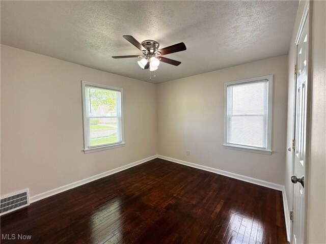 19708 Sunset Dr, Warrensville Heights, OH 44122 - spare room with a textured ceiling, baseboards, dark wood finished floors, and a ceiling fan