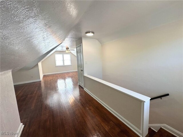 19708 Sunset Dr, Warrensville Heights, OH 44122 - bonus room with hardwood / wood-style floors, baseboards, lofted ceiling, a textured ceiling, and a ceiling fan